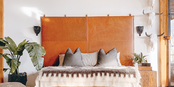 large wall mount leather headboard in loft with white shag rug