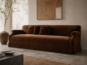 Custom chocolate brown velvet sofa with rolled arms, single bench cushion and tailored center-pleat skirt by HF Atelier