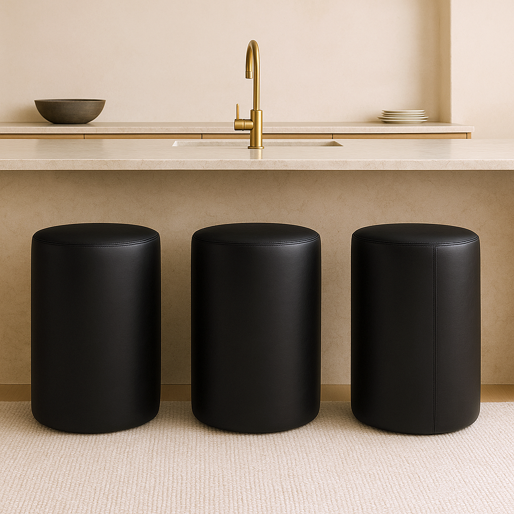 black Modern round bar stool in full-grain leather with minimalist cylindrical shape placed in a neutral-toned luxury kitchen