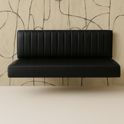Black leather bench against a beige wall with abstract line patterns