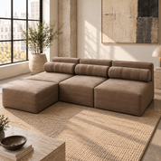 Natural buffalo hide modular sofa and ottoman in warm taupe leather, three quarter view