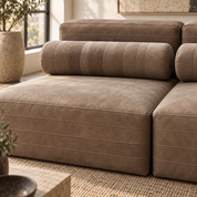 Close up of thick natural buffalo hide sofa leather, horizontal stitching and cylindrical bolster pillow