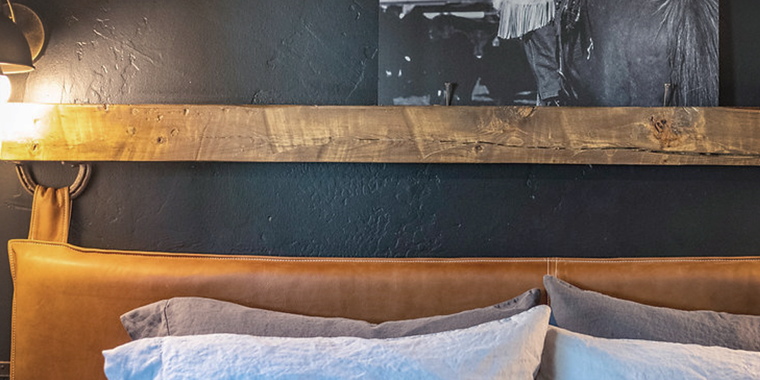 country-cabin-bedroom-decor-with-leather-headboard-and-leather-pillows-by-HUNTEDFOX.png