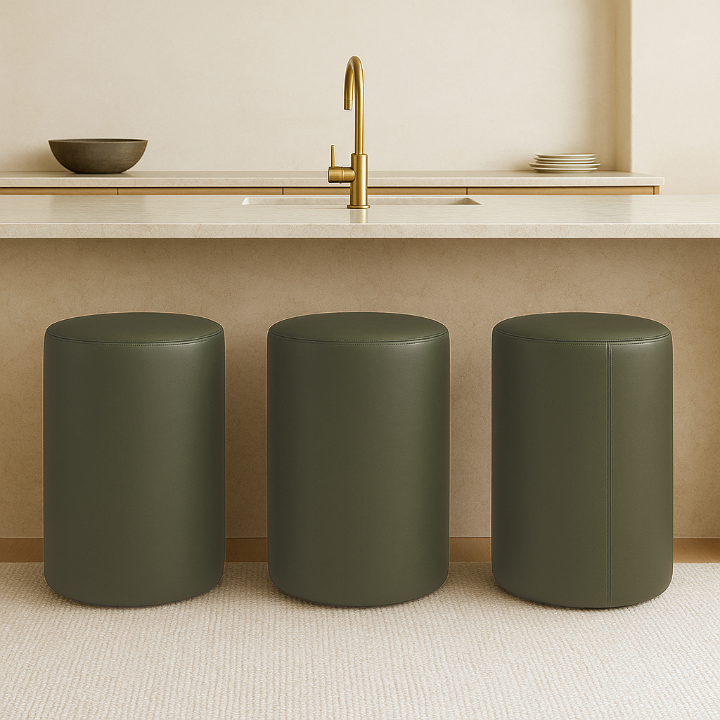 green Modern round bar stool in full-grain leather with minimalist cylindrical shape placed in a neutral-toned luxury kitchen