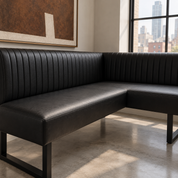 Close-up of HF Atelier black leather corner dining banquette showing vertical ribbed upholstery, smooth seat and black metal base