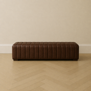 Dark chocolate leather ribbed bench ottoman by HF Atelier with vertical channel upholstery in a minimalist room with herringbone flooring