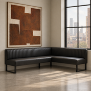 Modern black leather L-shaped corner dining banquette with vertical ribbed back in a contemporary city loft by HF Atelier