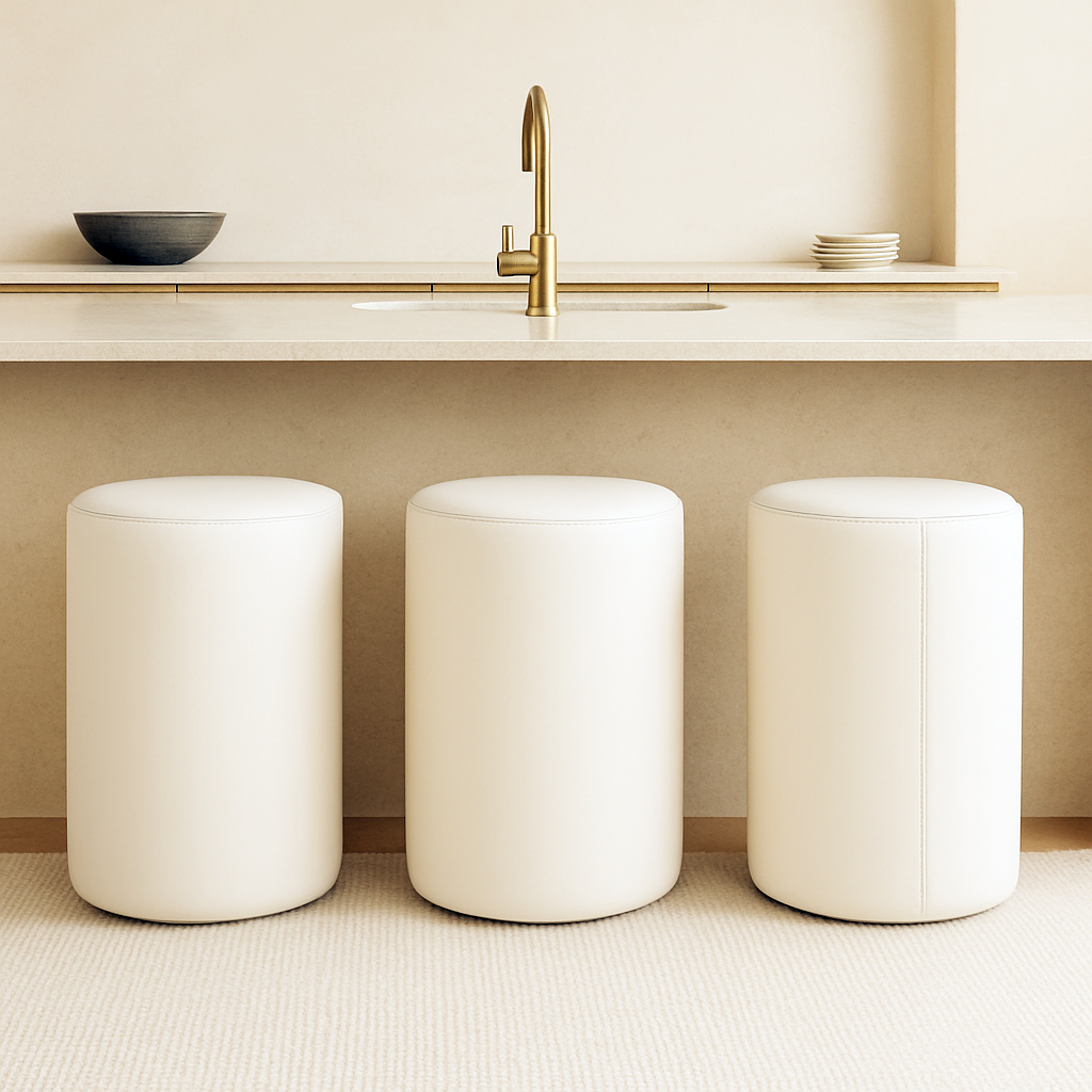 ivory white Modern round bar stool in full-grain leather with minimalist cylindrical shape placed in a neutral-toned luxury kitchen