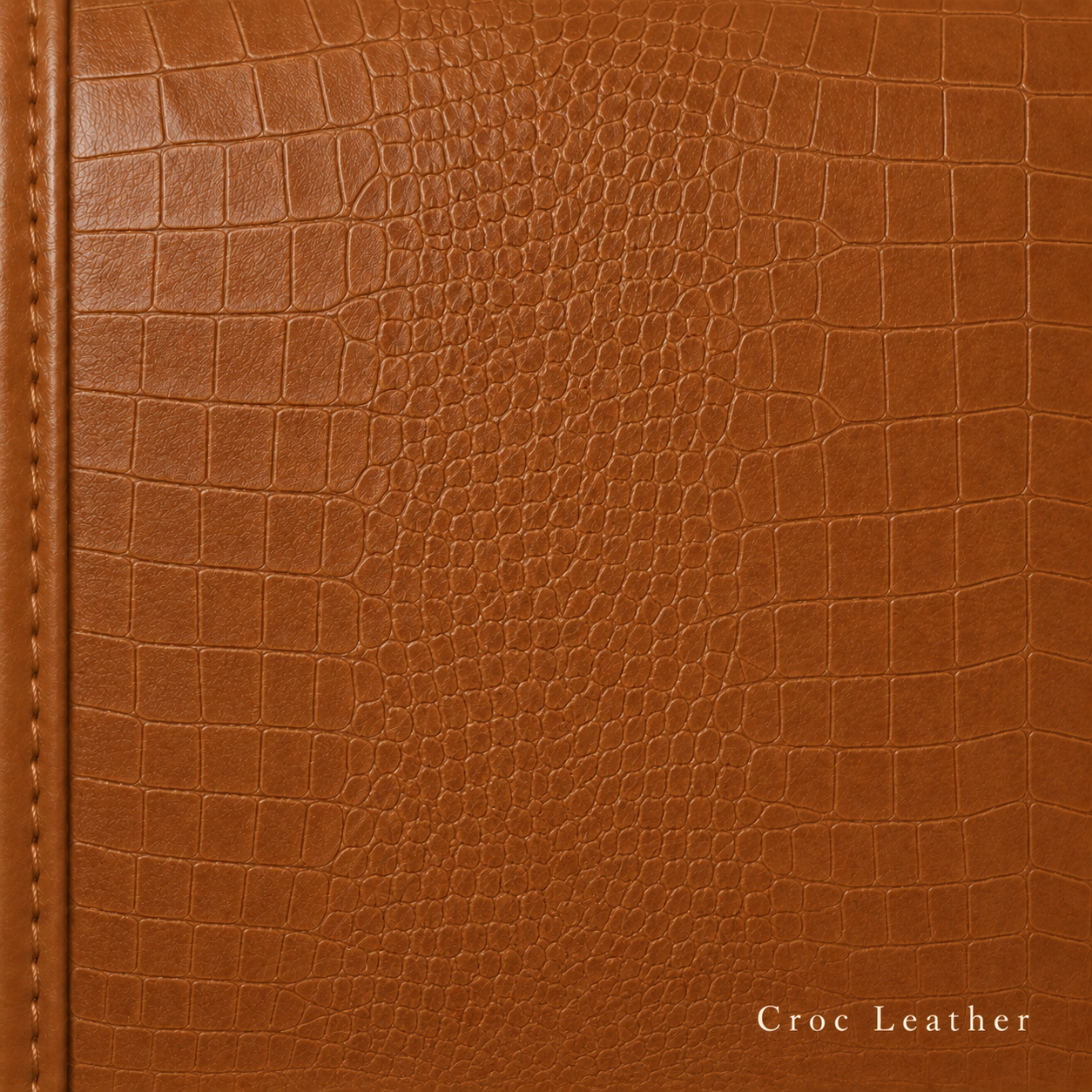 Close-up of brown crocodile leather texture with stitching detail